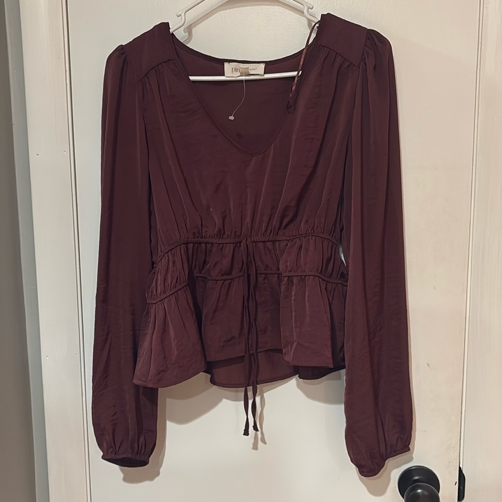 Burgundy long sleeve polyester, stretches if needed comfortable